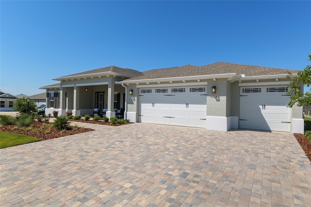 9764 SW 81st Ln, Ocala, FL 34481 - prairie-style house featuring an attached garage, stucco siding, and decorative driveway