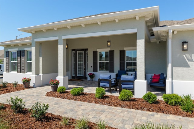 9764 SW 81st Ln, Ocala, FL 34481 - view of exterior entry featuring covered porch, roof with shingles, and stucco siding