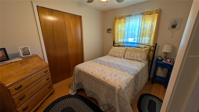 bedroom featuring wood finished floors, a closet, and ceiling fan