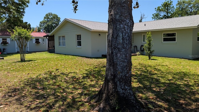 rear view of property with a yard