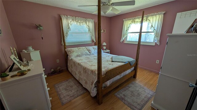 2219 NE 18th Ave, Ocala, FL 34470 - bedroom with multiple windows, light wood-style floors, a textured ceiling, and ceiling fan