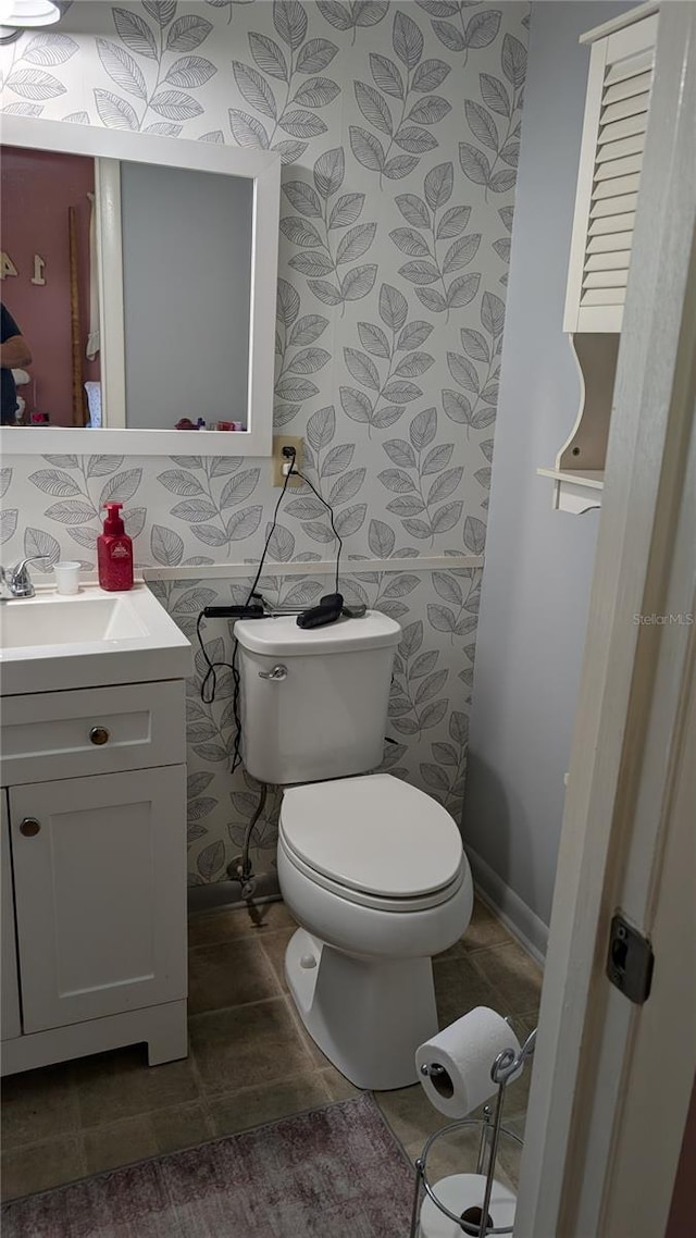 2219 NE 18th Ave, Ocala, FL 34470 - bathroom featuring toilet, vanity, tile patterned floors, and baseboards