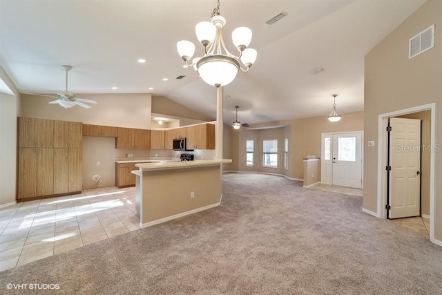 kitchen with light countertops, visible vents, and ceiling fan with notable chandelier