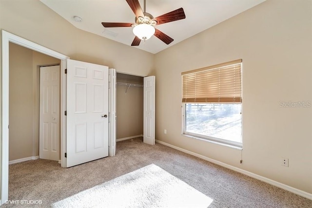 unfurnished bedroom featuring ceiling fan, baseboards, a closet, and carpet