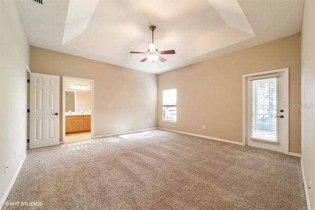 empty room featuring baseboards, light colored carpet, ceiling fan, and a healthy amount of sunlight