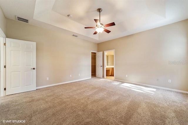 unfurnished bedroom with light carpet, visible vents, and baseboards