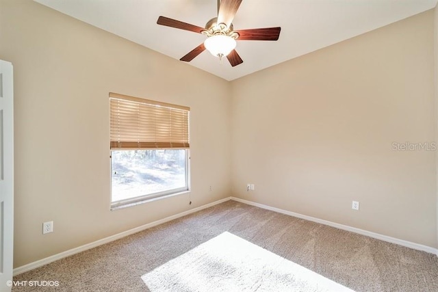unfurnished room featuring carpet floors, baseboards, and ceiling fan
