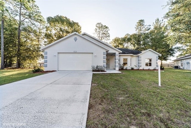 ranch-style home featuring fence, a front lawn, stucco siding, an attached garage, and concrete driveway