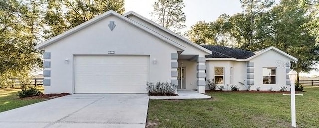 ranch-style house with fence, a front lawn, stucco siding, an attached garage, and concrete driveway