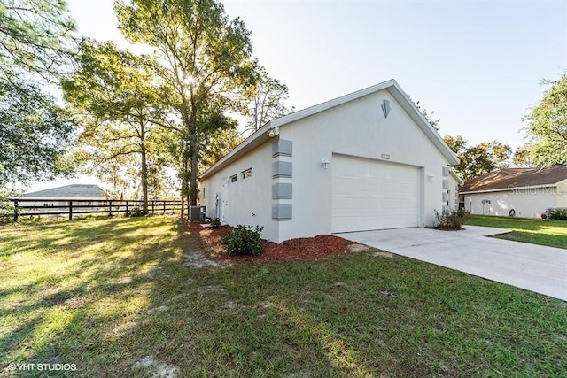 view of home's exterior featuring driveway, central AC, fence, a garage, and a lawn