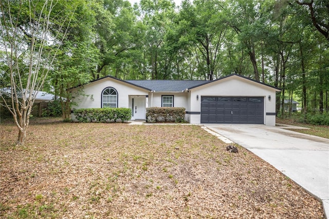 ranch-style house with concrete driveway, an attached garage, roof with shingles, and stucco siding