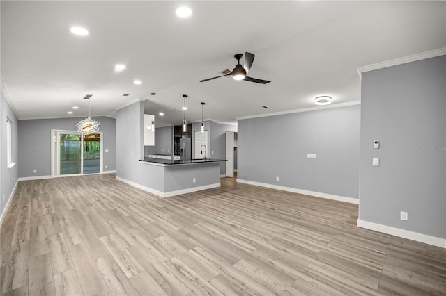 unfurnished living room featuring lofted ceiling, light wood-type flooring, crown molding, and baseboards