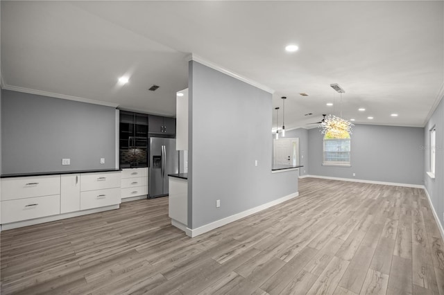 unfurnished living room with light wood-style flooring, a ceiling fan, and crown molding
