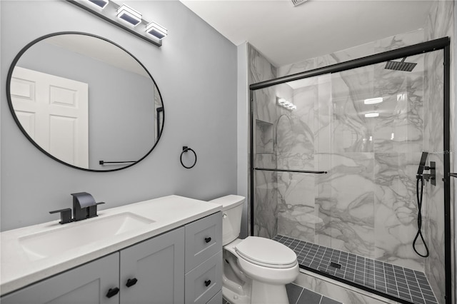bathroom with toilet, vanity, and a marble finish shower