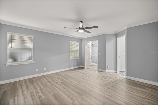 unfurnished bedroom with light wood-style floors, crown molding, and baseboards