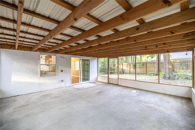 unfurnished living room with unfinished concrete floors and plenty of natural light