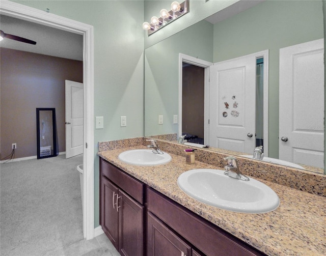 5198 NE 19th Pl, Ocala, FL 34470 - bathroom with ceiling fan, baseboards, a sink, and double vanity