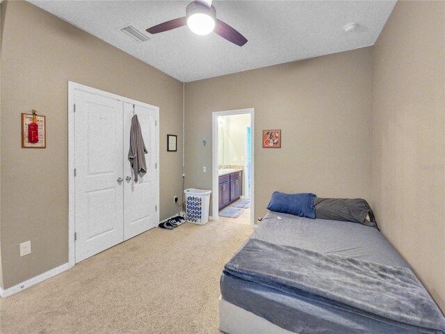 5198 NE 19th Pl, Ocala, FL 34470 - carpeted bedroom with a ceiling fan, ensuite bathroom, a closet, baseboards, and visible vents
