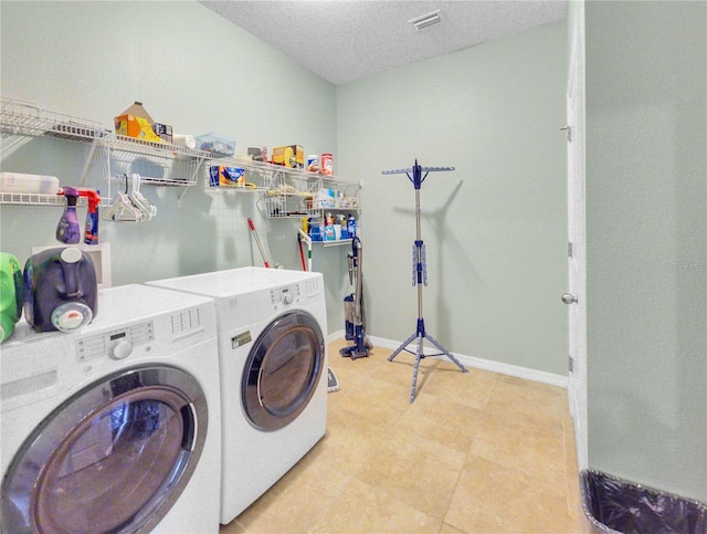 5198 NE 19th Pl, Ocala, FL 34470 - washroom with a textured ceiling, laundry area, washing machine and dryer, baseboards, and visible vents