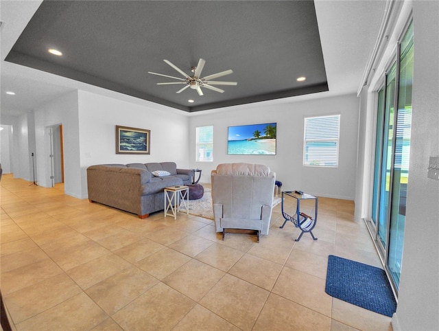 5198 NE 19th Pl, Ocala, FL 34470 - living area with ceiling fan, light tile patterned flooring, a tray ceiling, and recessed lighting