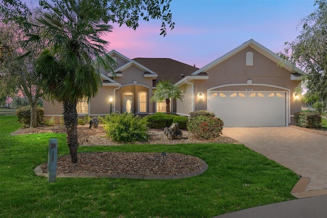 8632 SW 86th Cir, Ocala, FL 34481 - ranch-style home with decorative driveway, a garage, a front lawn, and stucco siding