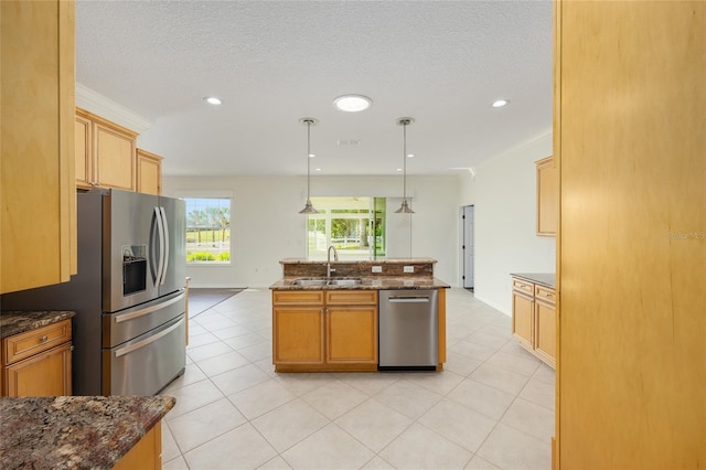 8632 SW 86th Cir, Ocala, FL 34481 - kitchen with pendant lighting, a kitchen island with sink, dark stone counters, a sink, and stainless steel appliances