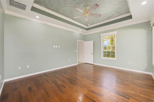 8632 SW 86th Cir, Ocala, FL 34481 - empty room with visible vents, a raised ceiling, crown molding, and wood-type flooring