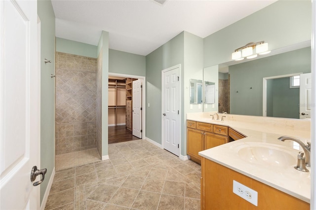 8632 SW 86th Cir, Ocala, FL 34481 - full bath featuring tile patterned flooring, double vanity, a spacious closet, a sink, and a tile shower