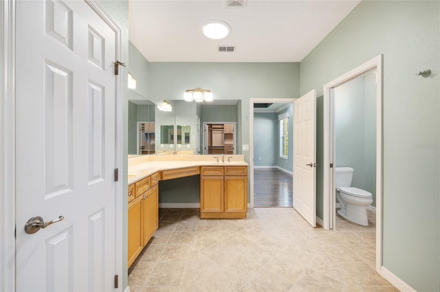 8632 SW 86th Cir, Ocala, FL 34481 - bathroom with visible vents, double vanity, toilet, tile patterned floors, and a sink