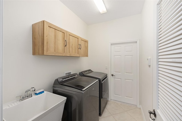 8632 SW 86th Cir, Ocala, FL 34481 - laundry room featuring washer and dryer, light tile patterned floors, a sink, and cabinet space