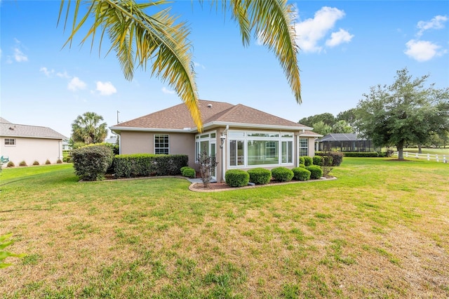 8632 SW 86th Cir, Ocala, FL 34481 - rear view of property featuring a lawn and stucco siding