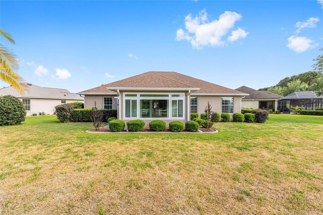 8632 SW 86th Cir, Ocala, FL 34481 - rear view of property featuring a lawn and stucco siding