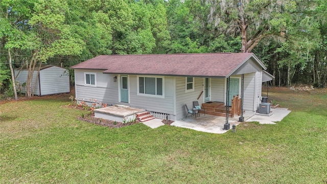 4180 W Anthony Rd, Ocala, FL 34475 - exterior space with a porch, roof with shingles, a front yard, and central AC