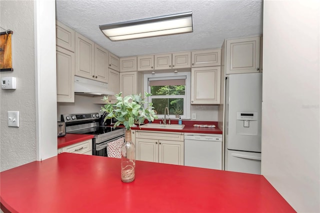4180 W Anthony Rd, Ocala, FL 34475 - kitchen with cream cabinets, under cabinet range hood, a sink, and white appliances