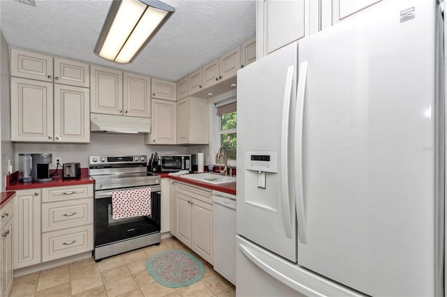 4180 W Anthony Rd, Ocala, FL 34475 - kitchen featuring under cabinet range hood, a sink, white appliances, a textured ceiling, and cream cabinets