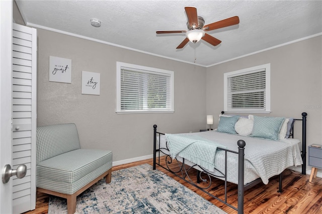 4180 W Anthony Rd, Ocala, FL 34475 - bedroom featuring wood finished floors, a textured ceiling, and baseboards
