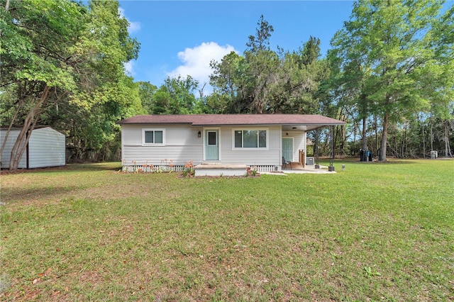 4180 W Anthony Rd, Ocala, FL 34475 - view of front of home featuring a front lawn, an outdoor structure, and a shed