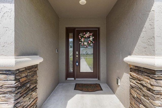entrance to property with stucco siding