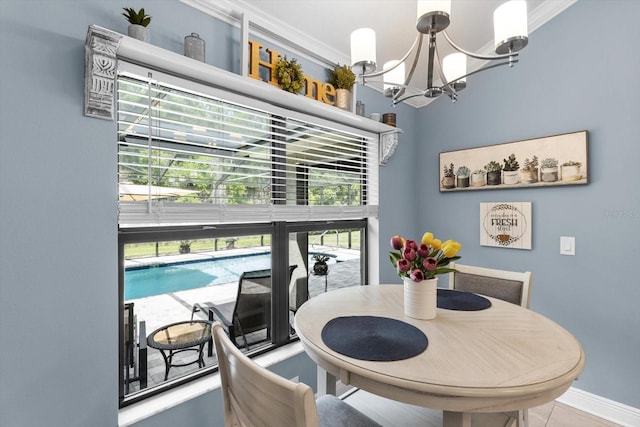 dining space featuring baseboards and a notable chandelier