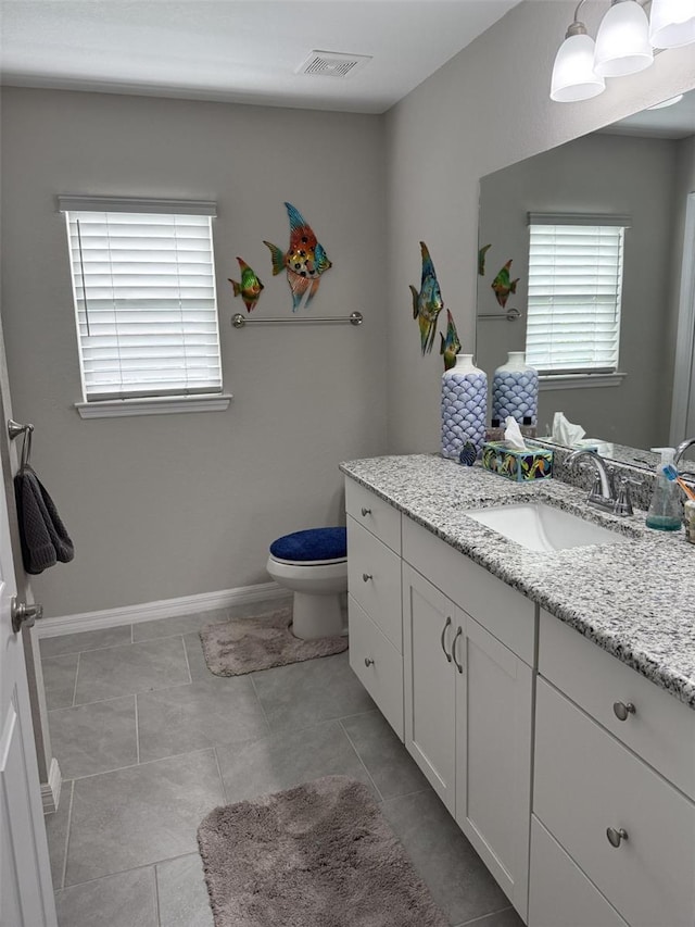 bathroom with toilet, tile patterned floors, visible vents, baseboards, and vanity