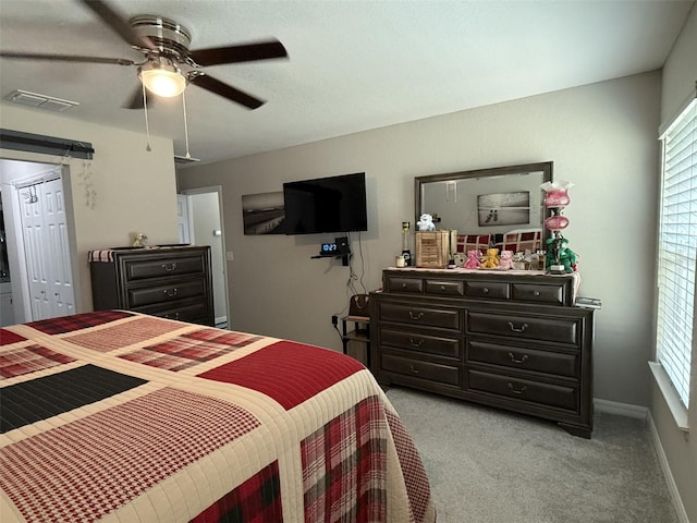 bedroom with visible vents, baseboards, a ceiling fan, and light carpet