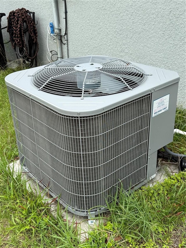 details featuring central AC unit and stucco siding