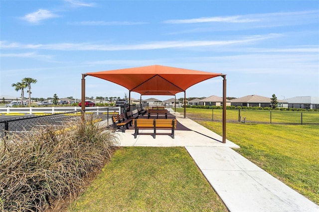 view of jungle gym with a gazebo, a yard, and fence