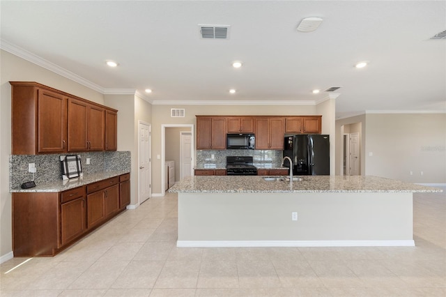 8952 SW 79th Ln, Ocala, FL 34481 - kitchen with decorative backsplash, visible vents, a sink, and black appliances
