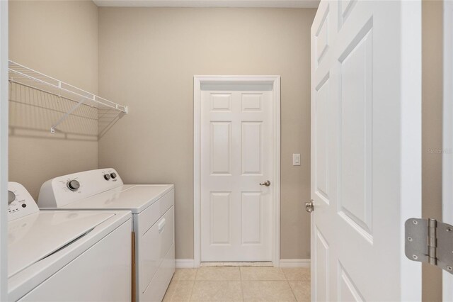 8952 SW 79th Ln, Ocala, FL 34481 - washroom featuring baseboards, independent washer and dryer, laundry area, and light tile patterned flooring