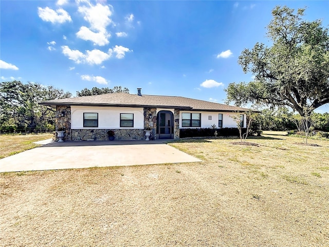 4806 SW County Road 769, Arcadia, FL 34269 - view of front of house with a front lawn, stucco siding, driveway, and stone siding