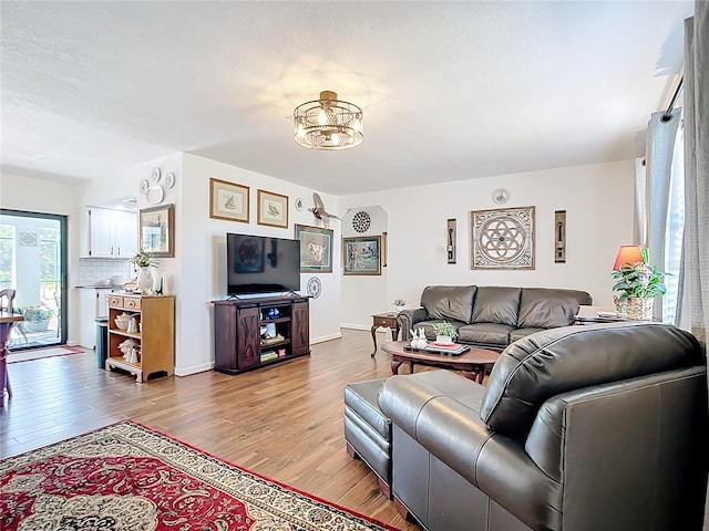 4806 SW County Road 769, Arcadia, FL 34269 - living room with an inviting chandelier, baseboards, and wood finished floors