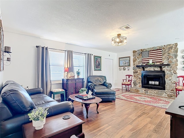 4806 SW County Road 769, Arcadia, FL 34269 - living area featuring a textured ceiling, visible vents, wood finished floors, and a fireplace