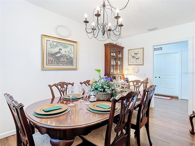 4806 SW County Road 769, Arcadia, FL 34269 - dining area with visible vents, baseboards, wood finished floors, and an inviting chandelier