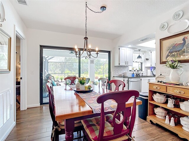 4806 SW County Road 769, Arcadia, FL 34269 - dining space with an inviting chandelier, wood finished floors, and visible vents